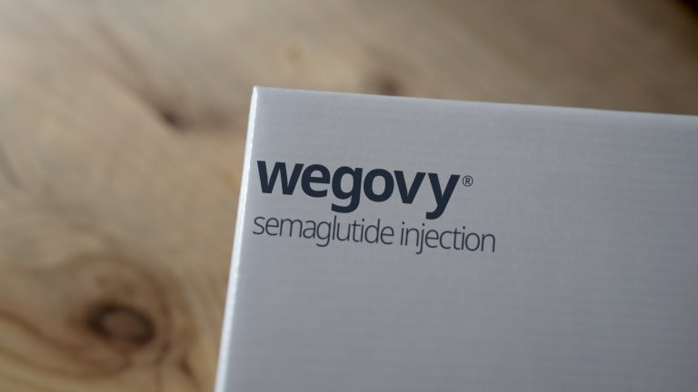 Close-up of a Wegovy injection pens packaging, showcasing the brand name, used for administering the medication to manage blood sugar levels and aid in weight loss