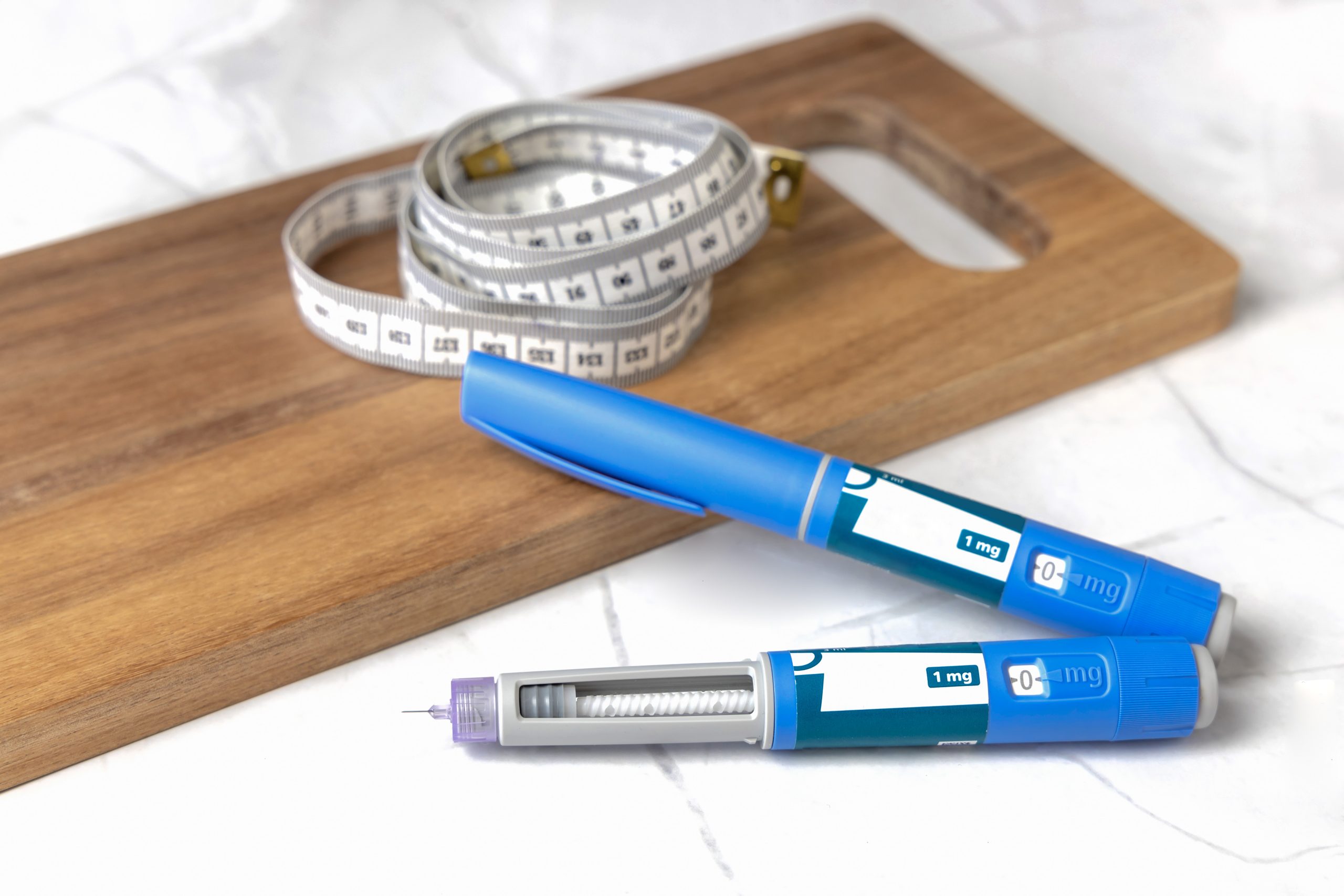 Close-up of a Wegovy injection pen on a counter, showcasing the small needle at the tip, used for administering the medication to manage blood sugar levels and aid in weight loss