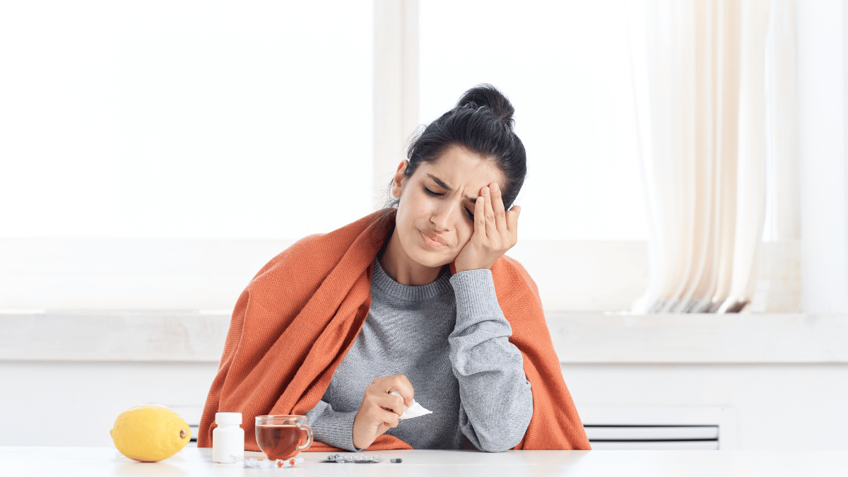 A woman experiencing cold vs. flu symptoms