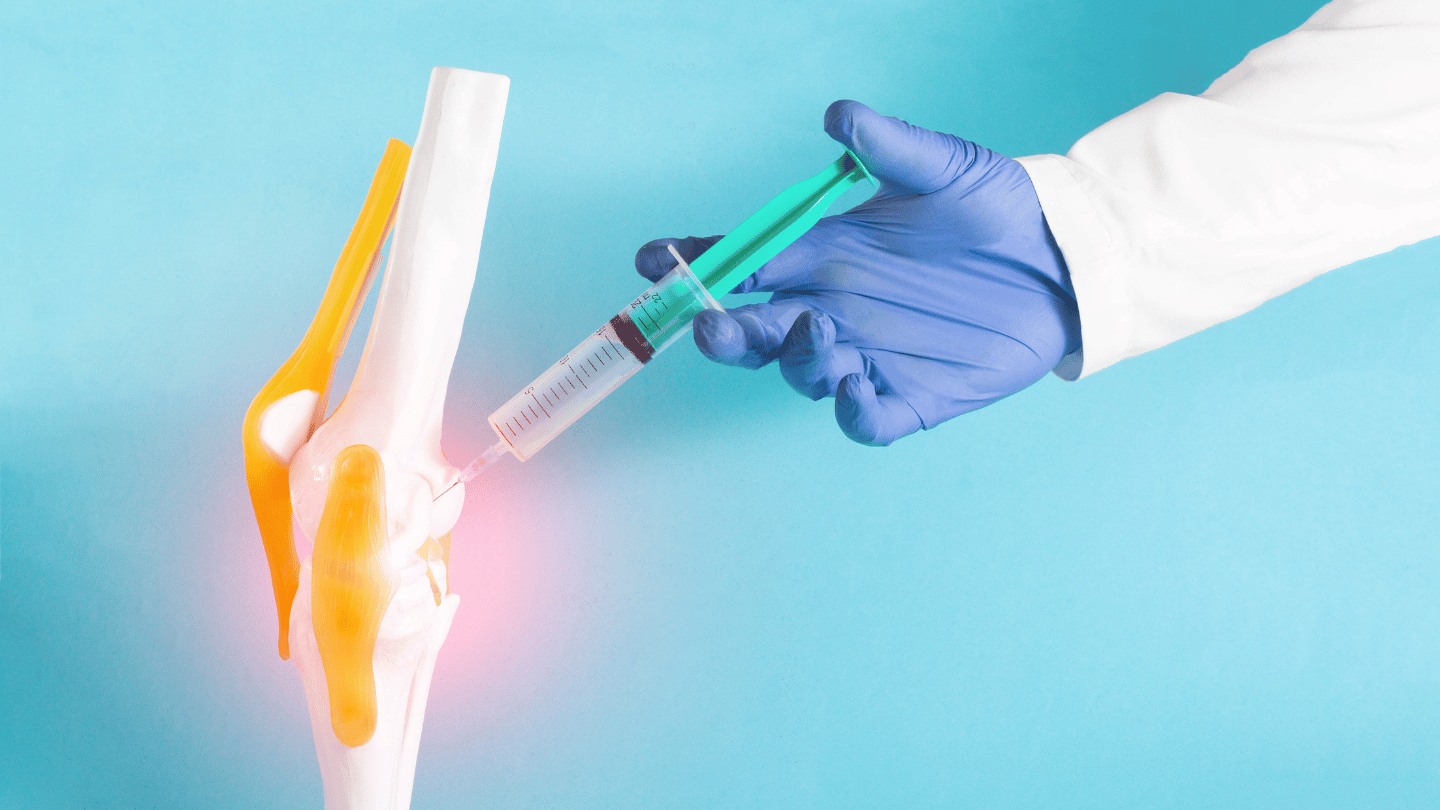 Doctor injecting prednisone and prednisolone into a model of a knee