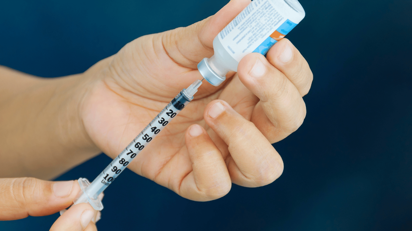 Person preparing insulin for injection