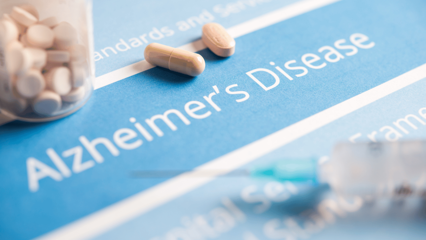 Aricept (Donepezil) pills on a paper saying Alzheimer's Disease