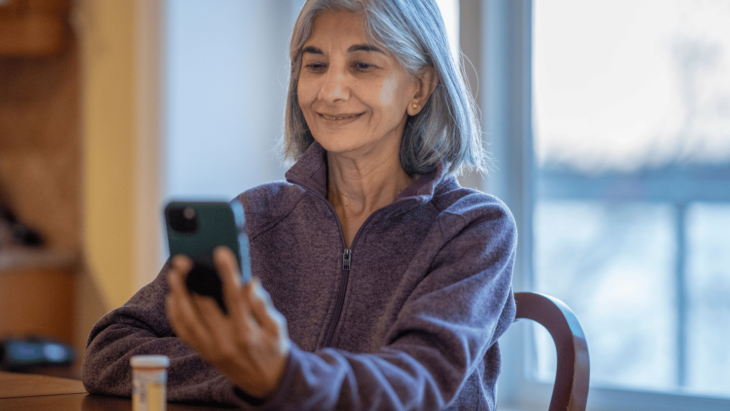 Woman using telehealth online services with QuickMD