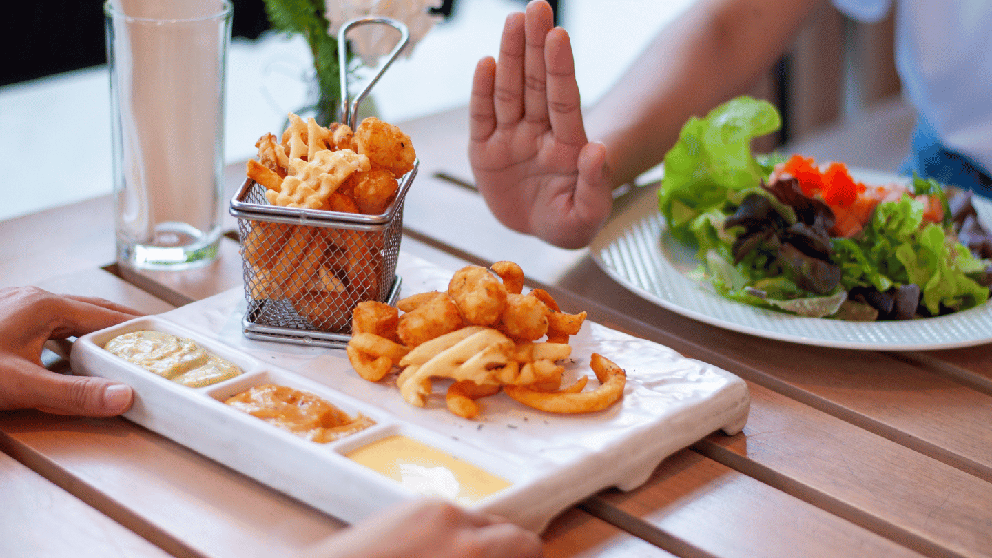 Person refusing to eat unhealthy foods to avoid while on Ozempic