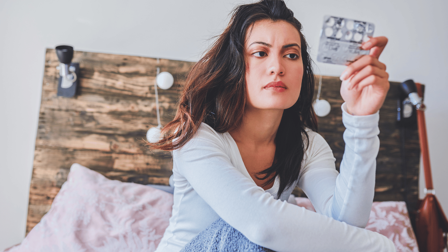 Woman looking at weight loss pills, considering Rybelsus side effects