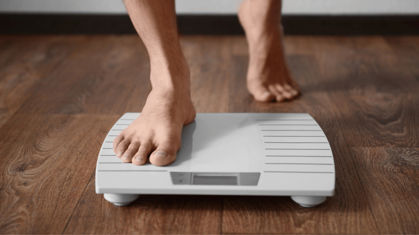 Close-up of a person stepping onto a digital scale, symbolizing the challenge of not losing weight on Ozempic despite following a treatment plan