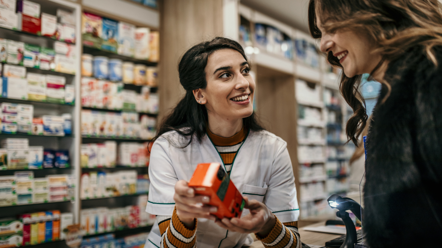 Pharmacist discussing the cost of semaglutide medication options with a customer, highlighting the importance of understanding weight loss treatment expenses without insurance