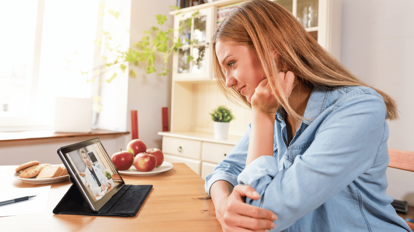 Patient having a telehealth consultation with a doctor via tablet for online Suboxone clinic treatment, highlighting the convenience and accessibility of QuickMD’s Tele-MOUD services