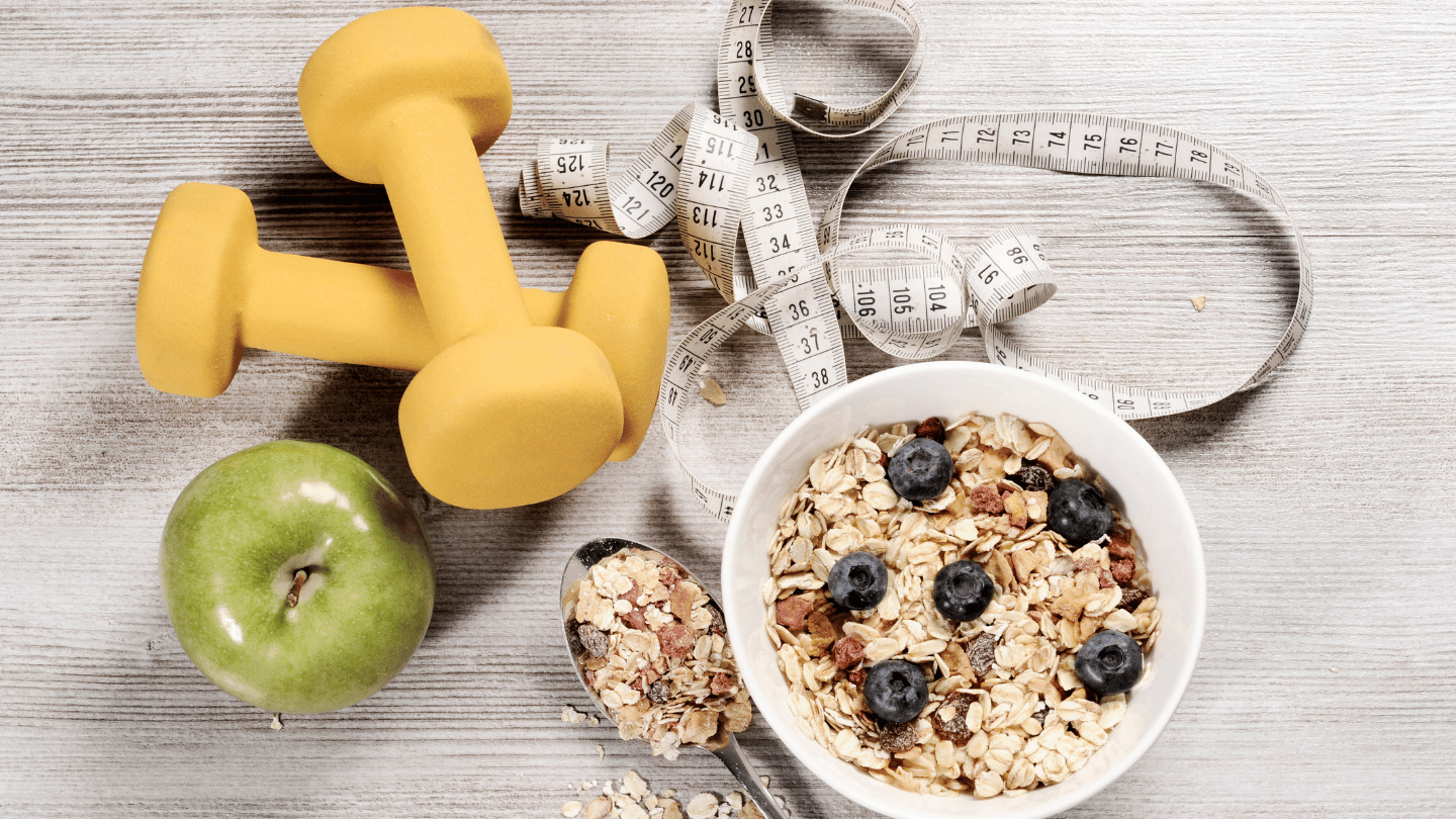 Essential tools for increasing weight loss on Wegovy: dumbbells, measuring tape, healthy oatmeal with blueberries, and a green apple