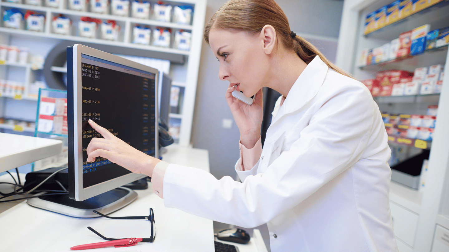 Pharmacist checking stock availability during the Ozempic shortage while on the phone with a patient