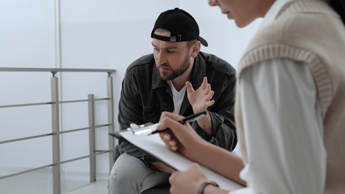 Man discussing opioid addiction treatment options with a healthcare provider during a consultation, highlighting the benefits of medications like Subutex and Suboxone