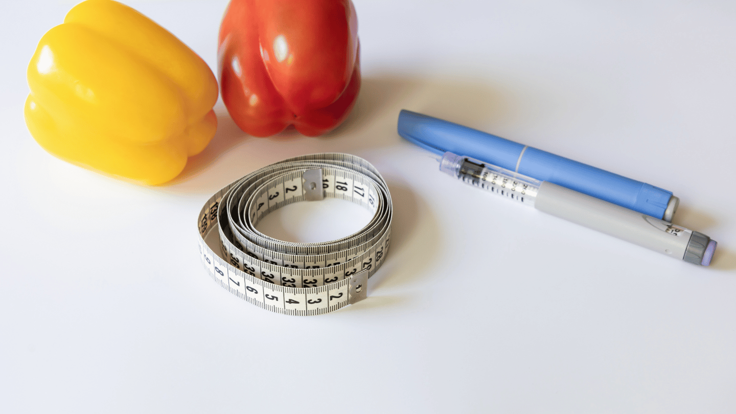 Semaglutide injection pen with measuring tape and fresh vegetables, symbolizing weight loss and diabetes management with Ozempic or Wegovy treatments