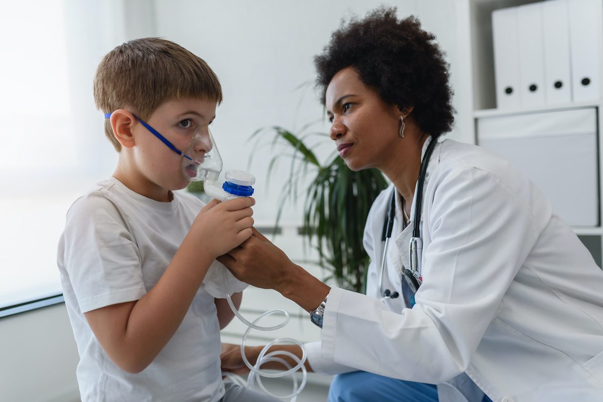 Doctor helping a child with RSV breathe