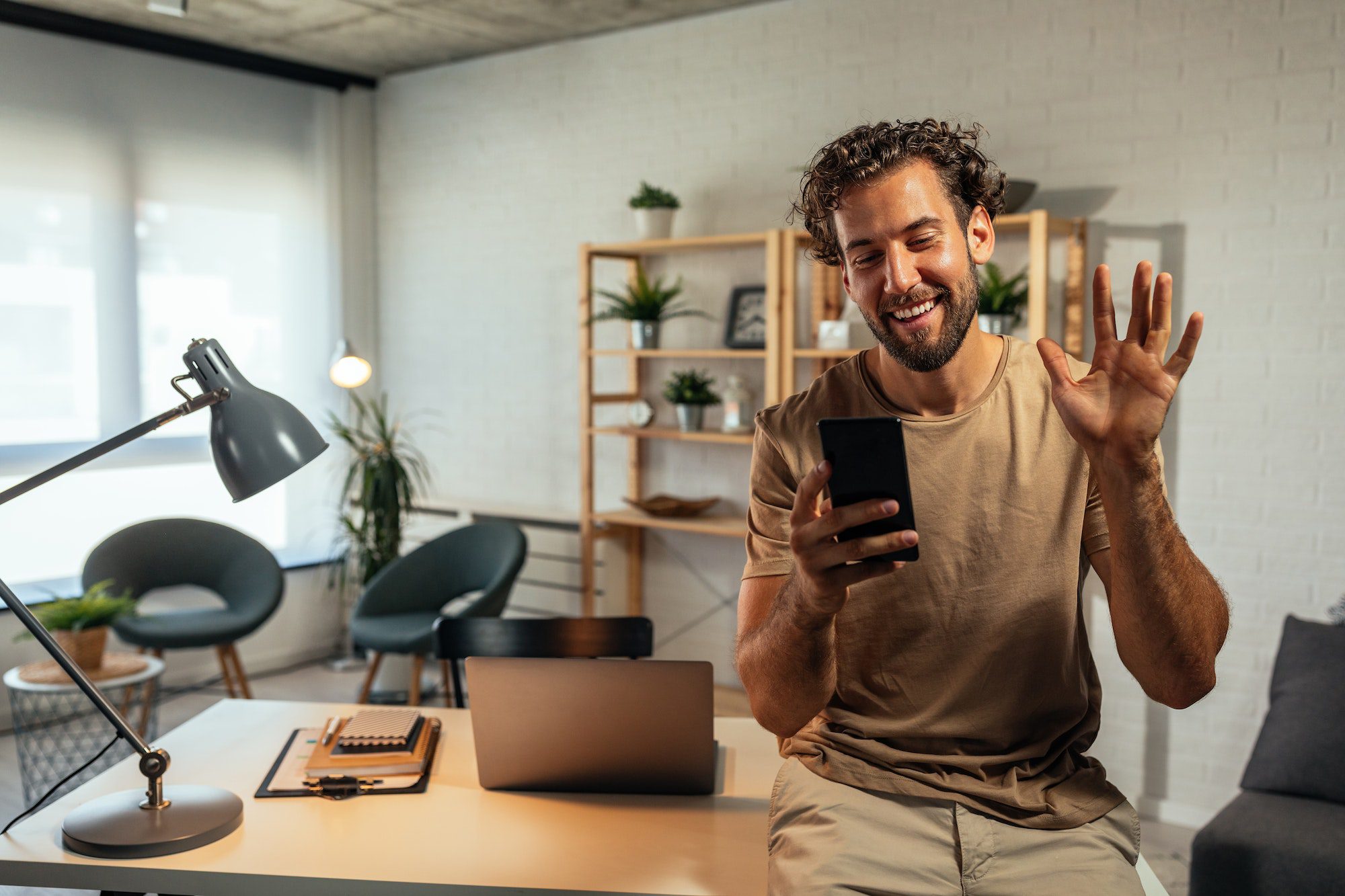 Man having an online addiction counseling session via telehealth on his smartphone, representing QuickMD's telehealth support services